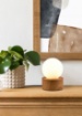 Immagine di Piccolo Lume da Comodino Countess Base Effetto Legno e Sfera Vetro Bianco Trio Lighting