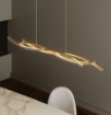 Immagine di Lampadario Da Tavolo Design Ondulato Kinetic Oro Led CCT Luce Ambiente Design